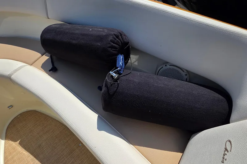 Slide: The Image of 2018 Chris-Craft Launch 23 boat interior with black cylindrical cushions. - 20