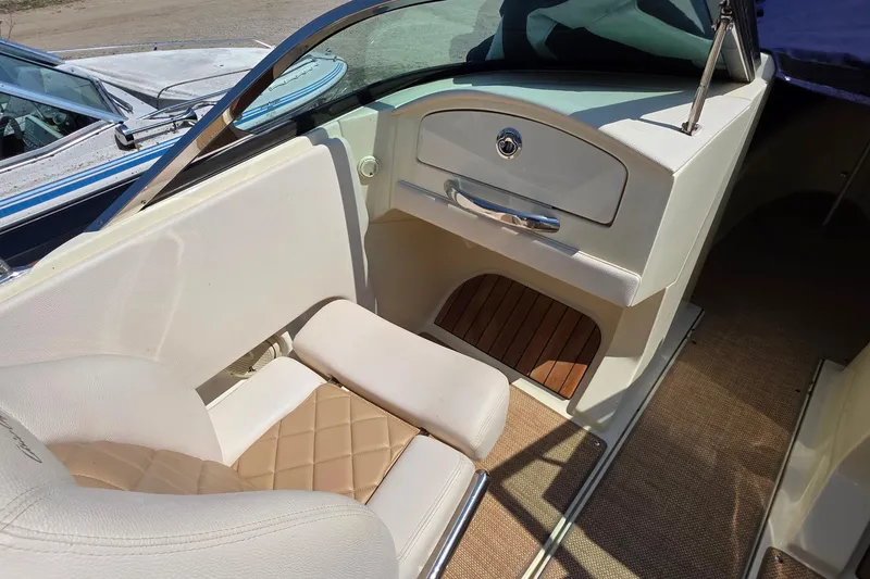 Slide: The Image of 2018 Chris-Craft Launch 23 interior with beige seating and wooden accents. - 21