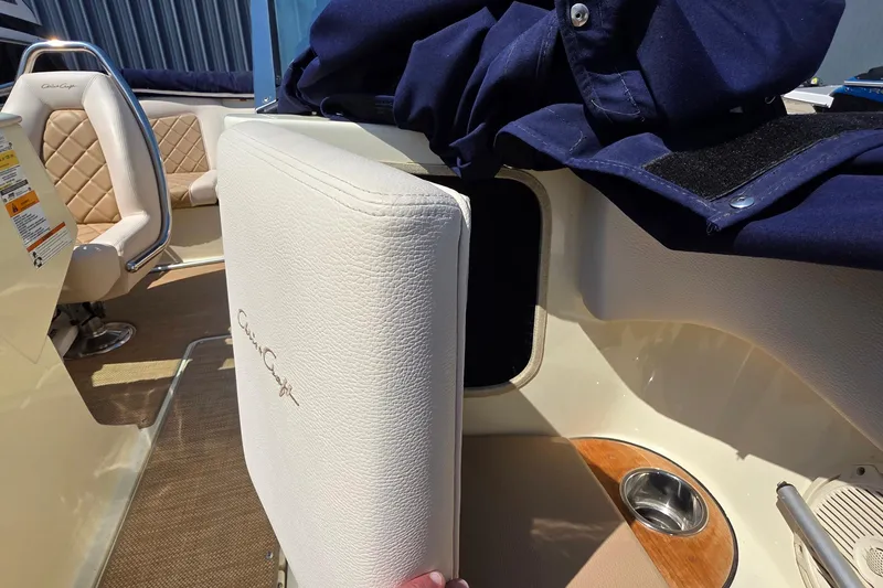 Slide: The Image of 2018 Chris-Craft Launch 23 interior with beige seating and storage compartment. - 22