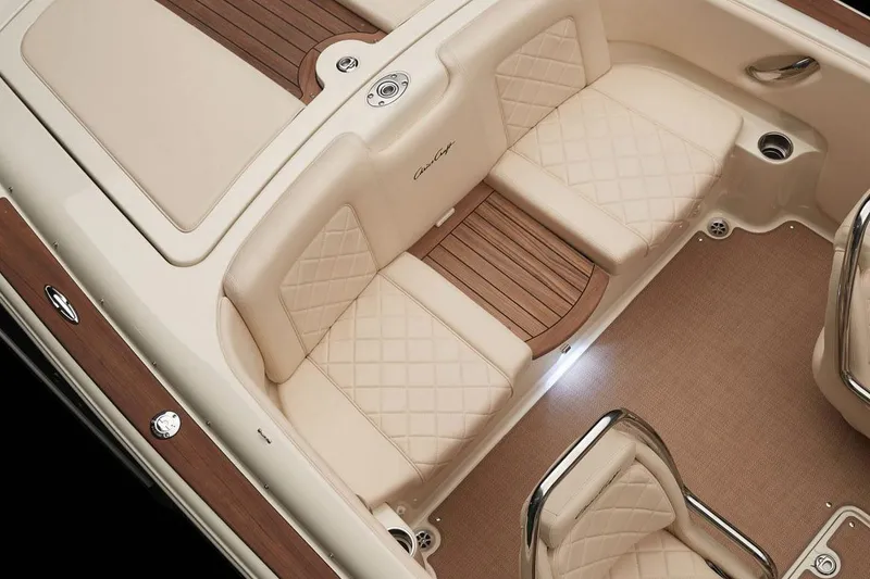 Slide: The Image of 2018 Chris-Craft Launch 23 boat on trailer outside a garage. - 7