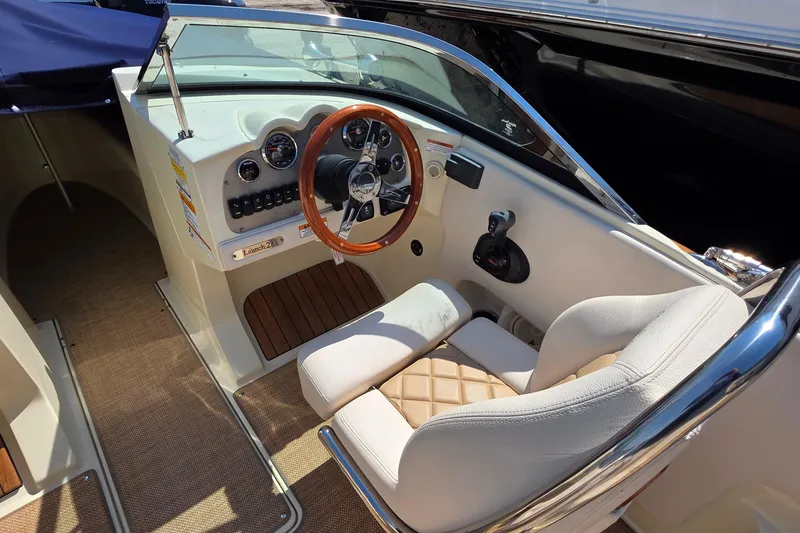 Slide: The Image of 2018 Chris-Craft Launch 23 boat interior with elegant steering wheel and plush seating. - 9