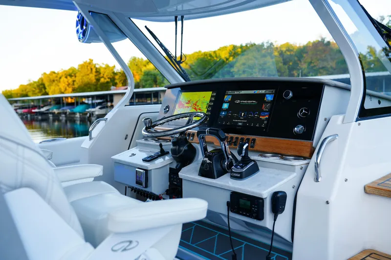 Slide: The Image of 2021 Regal 38 SAV boat cockpit with advanced navigation and control systems. - 20