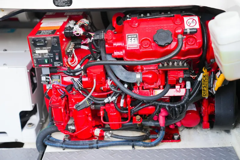 Slide: The Image of Engine compartment of a 2021 Regal 38 SAV boat, featuring a red multiport EFI system. - 23