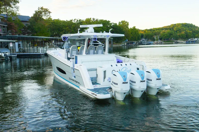 Slide: The Image of 2021 Regal 38 SAV boat with Yamaha engines on a serene lake. - 7