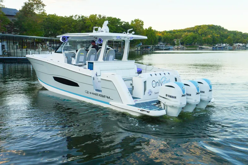 Slide: The Image of 2021 Regal 38 SAV boat with Yamaha engines on a serene lake. - 8