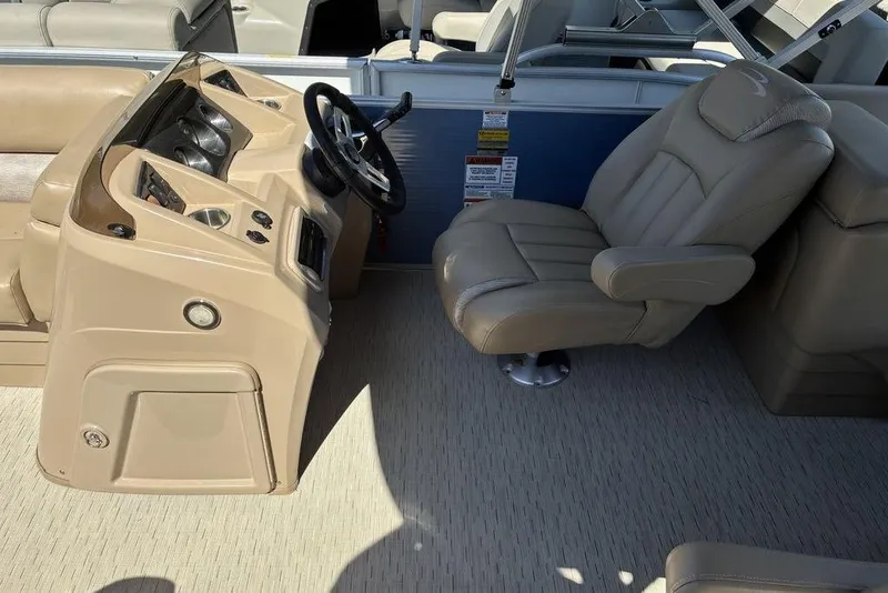 Slide: The Image of 2016 Bennington 22 SSRX boat interior with beige captain's chair and steering console. - 5