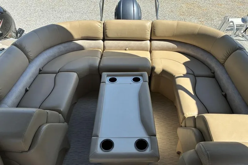 Slide: The Image of 2016 Bennington 22 SSRX pontoon boat with beige seating and central table. - 7
