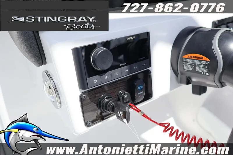 Slide: The Image of Control panel of 2026 Stingray 20 SBX boat with audio system and safety features. - 14
