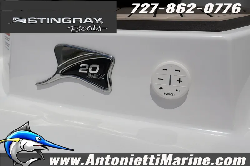 Slide: The Image of 2026 Stingray 20 SBX boat detail with Fusion audio controls and branding. - 8