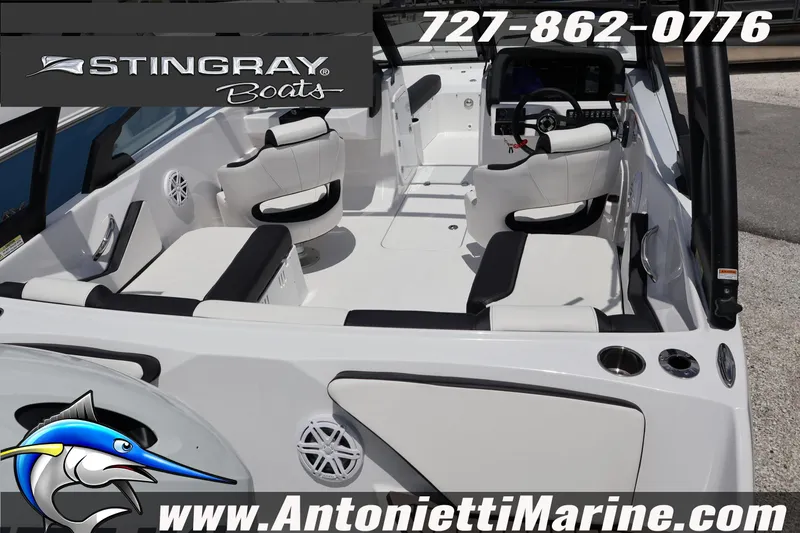 Slide: The Image of 2026 Stingray 20 SBX boat interior with white seating, steering console, and marine speakers. - 9