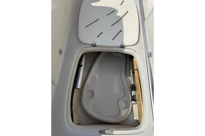 Slide: The Image of Open storage compartment in a 2013 Tahoe 195 I/O boat. - 10