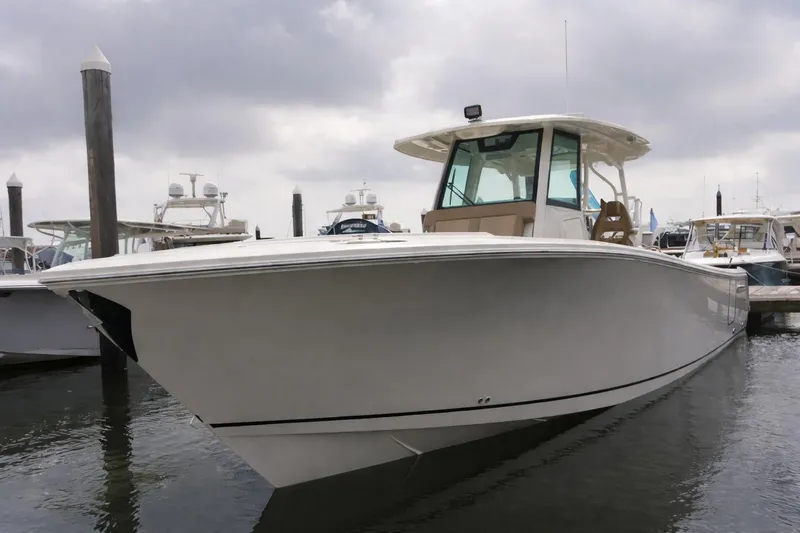 The Image of 2019 Sailfish 360 CC boat docked at marina under cloudy sky. - 0