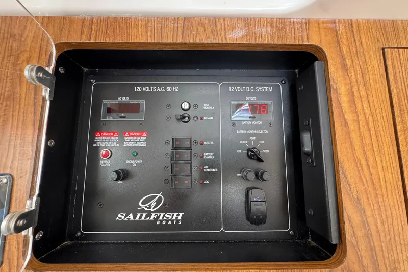 Slide: The Image of Control panel of a 2019 Sailfish 360 CC boat, featuring voltage and system switches. - 11