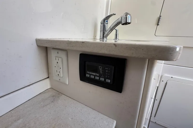Slide: The Image of Interior of 2019 Sailfish 360 CC boat with sink, outlet, and control panel. - 12