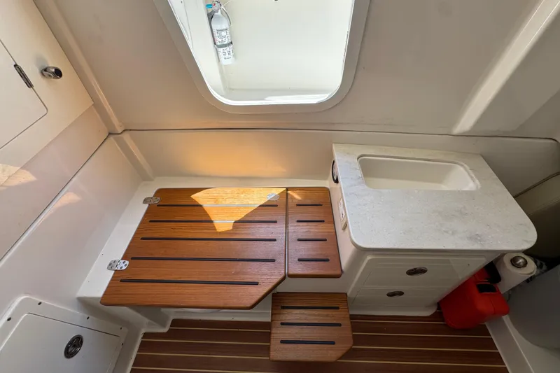 Slide: The Image of Interior of 2019 Sailfish 360 CC with wooden steps and sink. - 14