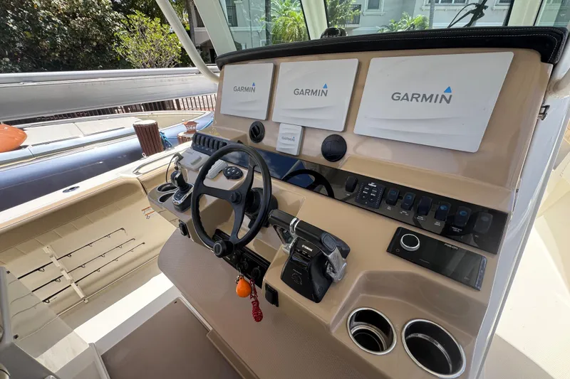 Slide: The Image of Helm of 2019 Sailfish 360 CC boat with Garmin navigation displays and controls. - 21