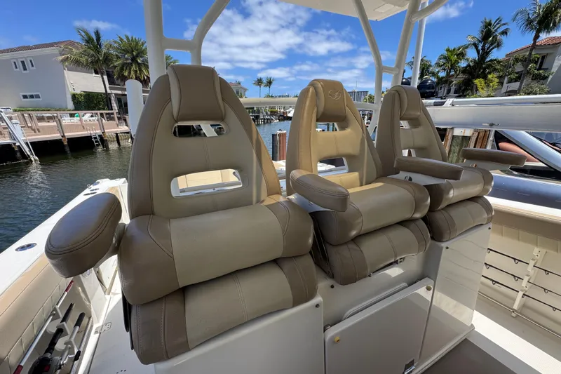 Slide: The Image of Luxury seating on 2019 Sailfish 360 CC boat, docked with palm trees in background. - 24