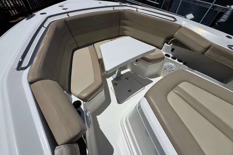 Slide: The Image of 2019 Sailfish 360 CC boat interior with beige seating and a central table. - 3