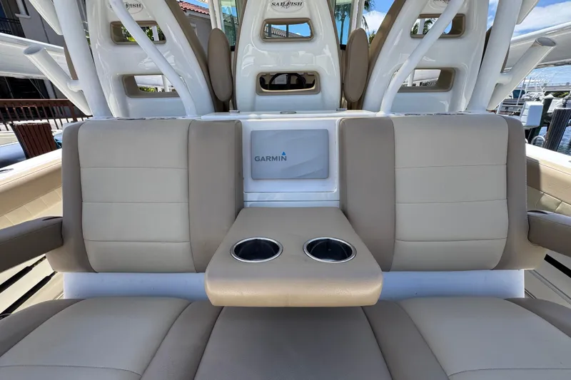 Slide: The Image of 2019 Sailfish 360 CC boat interior with beige seating and Garmin display. - 30