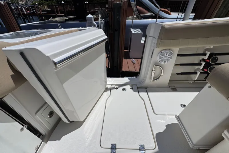 Slide: The Image of 2019 Sailfish 360 CC boat interior with rod holders and seating area. - 34
