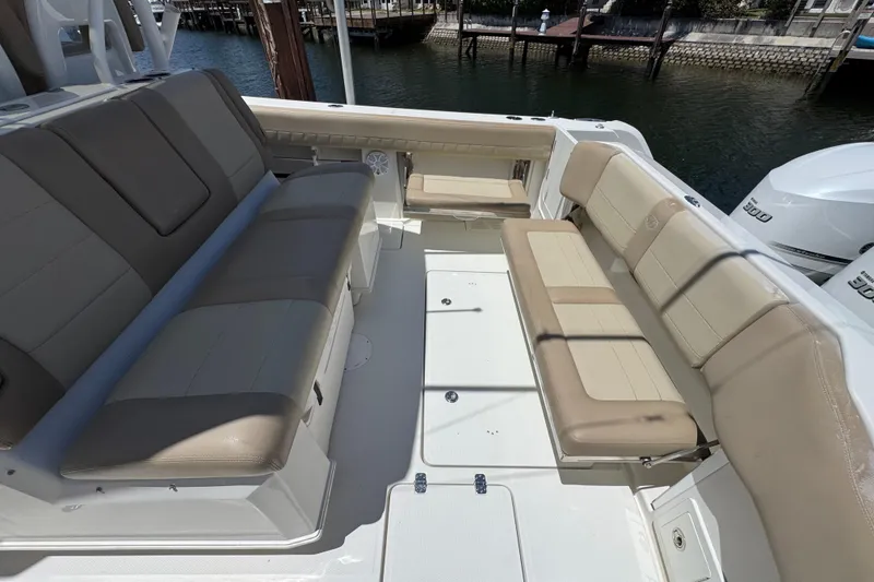 Slide: The Image of 2019 Sailfish 360 CC boat interior with beige seating and spacious deck area. - 36