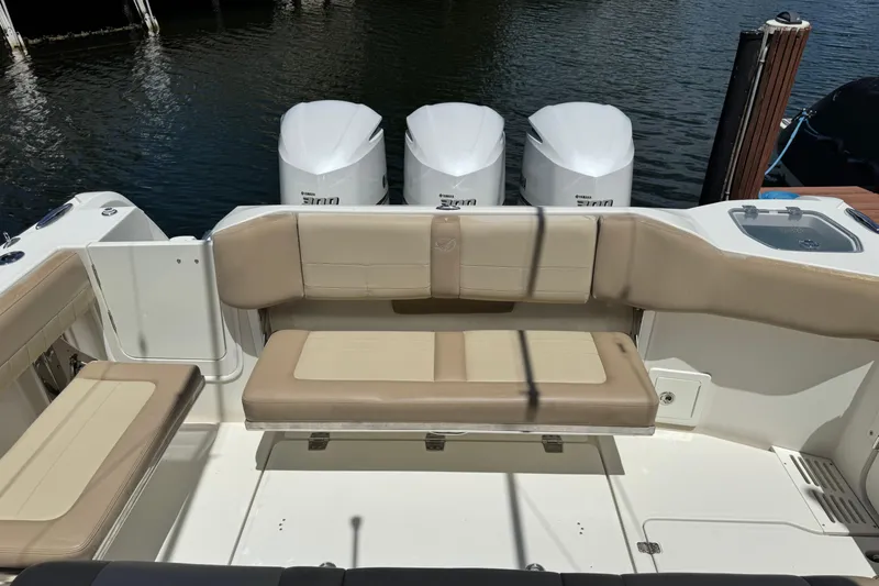 Slide: The Image of 2019 Sailfish 360 CC boat with beige seating and triple Yamaha engines. - 37