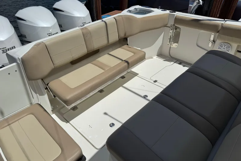 Slide: The Image of 2019 Sailfish 360 CC boat interior with beige seating and Yamaha engines. - 38