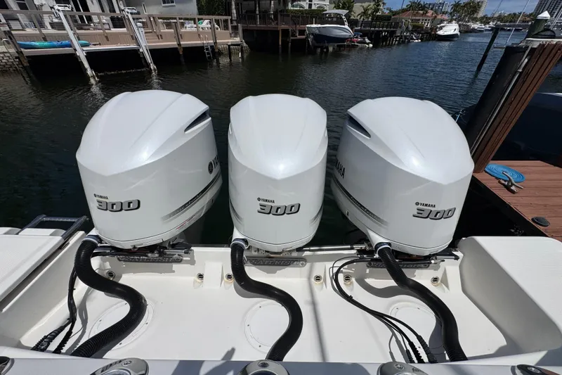 Slide: The Image of Triple Yamaha 300 engines on a 2019 Sailfish 360 CC boat docked by the waterfront. - 39