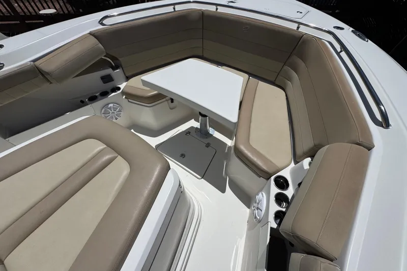 Slide: The Image of 2019 Sailfish 360 CC boat interior with beige seating and a central table. - 4