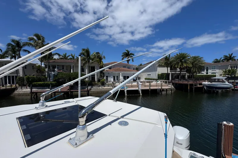 Slide: The Image of 2019 Sailfish 360 CC boat docked in a scenic waterfront area with palm trees. - 42