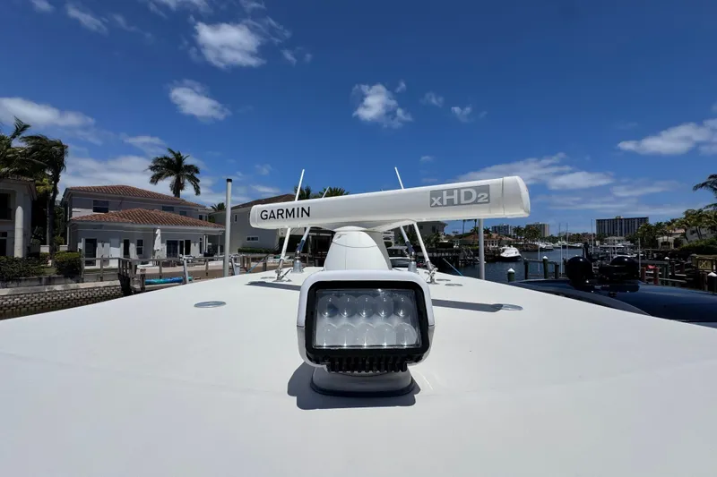 Slide: The Image of 2019 Sailfish 360 CC boat with Garmin xHD2 radar, docked under clear blue sky. - 43