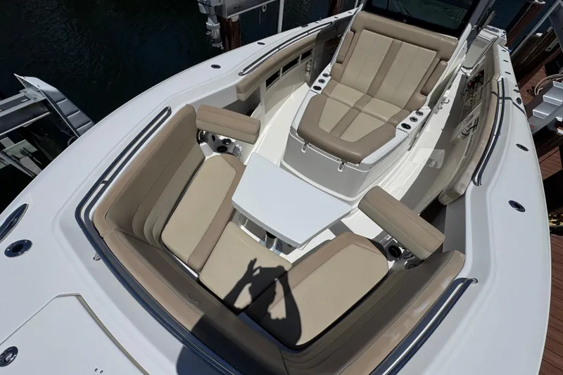 Slide: The Image of 2019 Sailfish 360 CC boat interior with beige seating and table. - 5