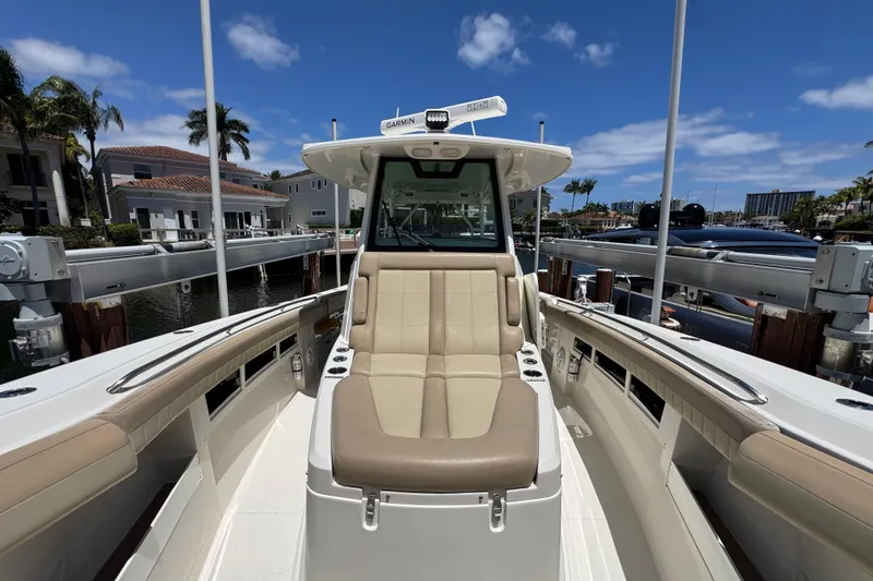 Slide: The Image of 2019 Sailfish 360 CC boat docked, featuring spacious seating and modern design. - 6