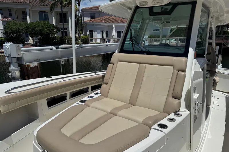 Slide: The Image of 2019 Sailfish 360 CC boat with beige seating and modern console design. - 7