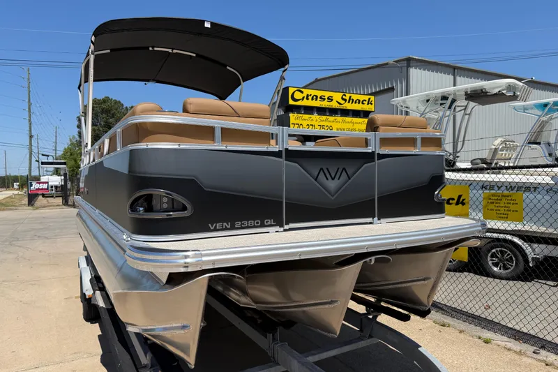 Slide: The Image of 2026 Avalon VENTURE QUAD LOUNGE pontoon boat displayed outdoors at dealership. - 2