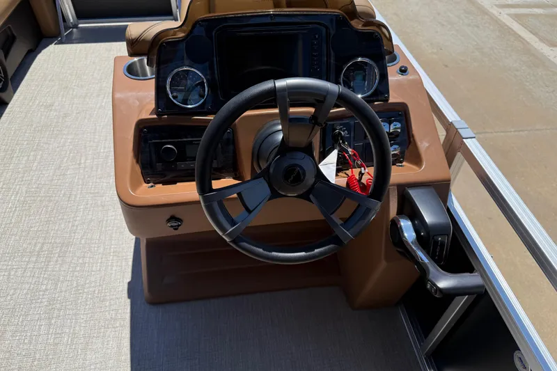 Slide: The Image of Steering console of 2026 Avalon VENTURE QUAD LOUNGE boat with modern controls and gauges. - 24