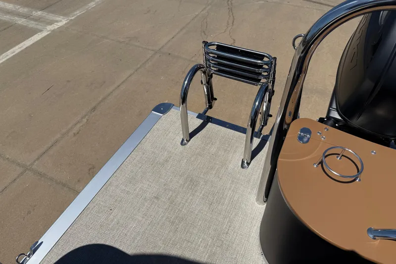 Slide: The Image of 2026 Avalon VENTURE QUAD LOUNGE boat deck with ladder and control panel. - 37