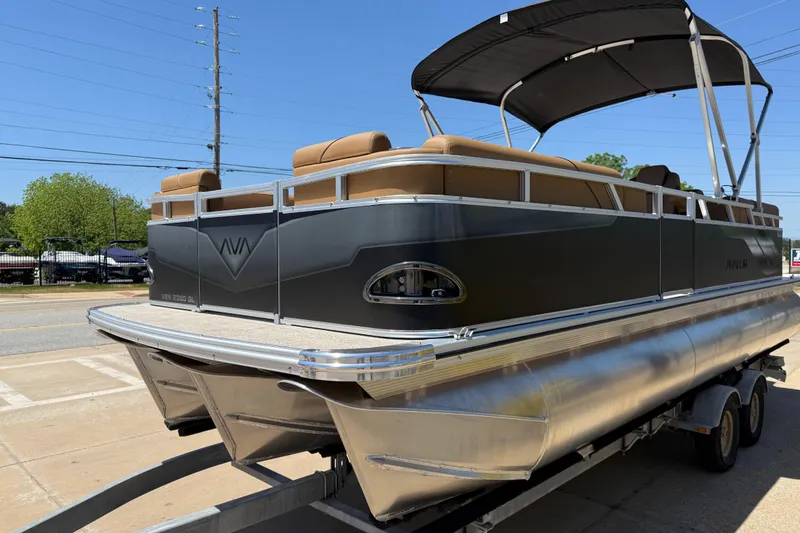 Slide: The Image of 2026 Avalon VENTURE QUAD LOUNGE pontoon boat on trailer, featuring sleek design and comfortable seating. - 4