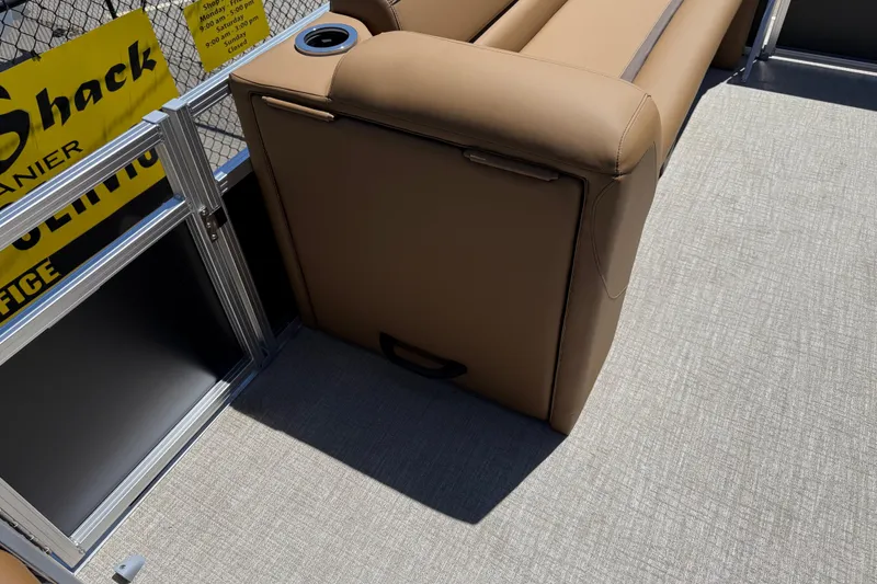 Slide: The Image of 2026 Avalon VENTURE QUAD LOUNGE interior with tan seating and cup holder on a boat deck. - 45