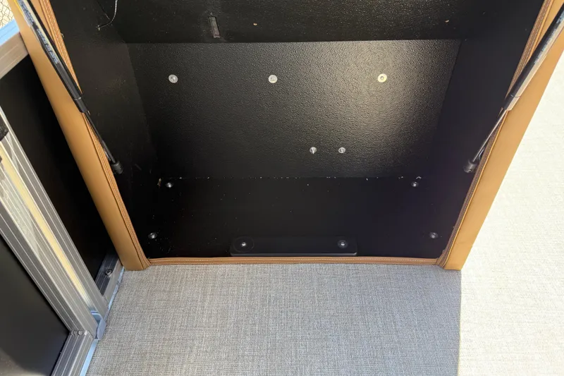 Slide: The Image of Interior storage compartment of 2026 Avalon VENTURE QUAD LOUNGE boat, featuring black and tan design. - 46