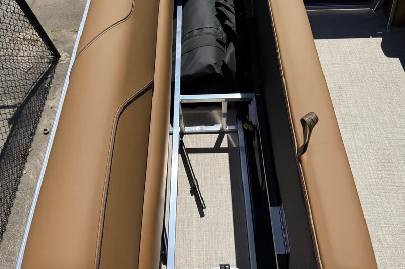 Slide: The Image of 2026 Avalon VENTURE QUAD LOUNGE interior storage compartment with tan seating and metal frame. - 49