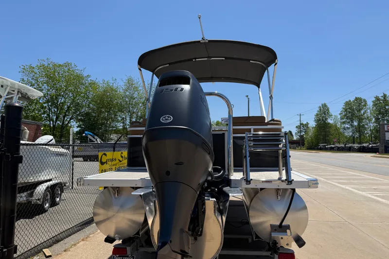 Slide: The Image of 2026 Avalon VENTURE QUAD LOUNGE pontoon boat with powerful outboard motor, parked outdoors. - 6