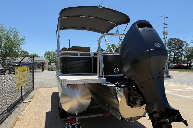 Slide: The Image of 2026 Avalon VENTURE QUAD LOUNGE pontoon boat with powerful outboard motor, parked outdoors. - 9