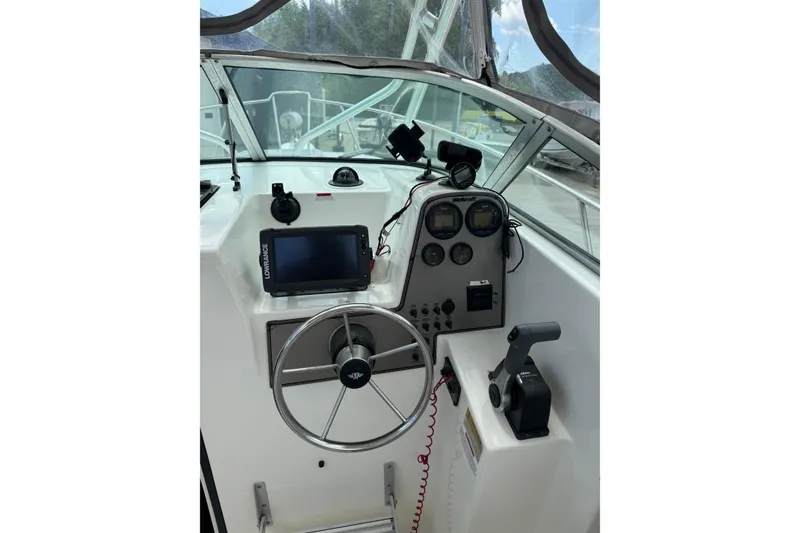 Slide: The Image of Cockpit of 2000 Wellcraft 22 Coastal Walkaround O/B with steering wheel and navigation equipment. - 10