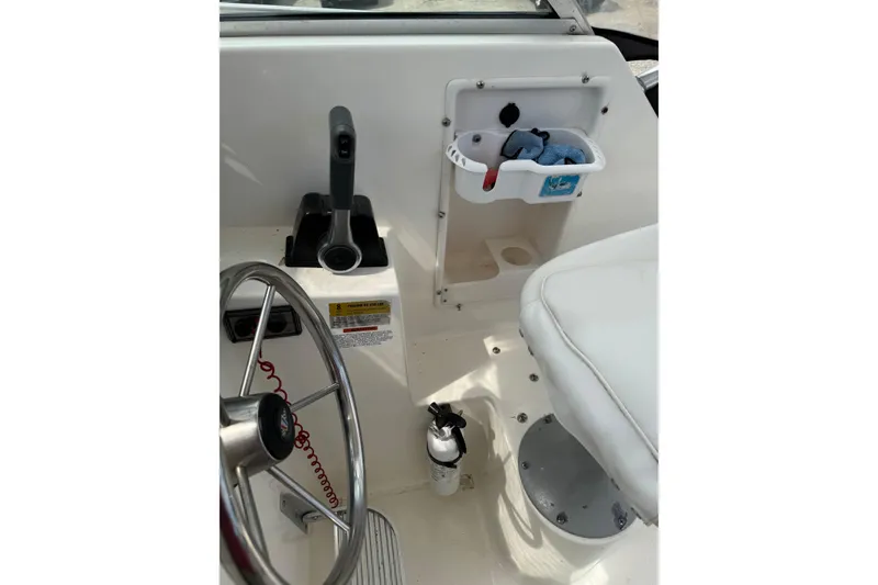 Slide: The Image of Interior view of 2000 Wellcraft 22 Coastal Walkaround O/B boat cockpit with steering wheel and controls. - 13