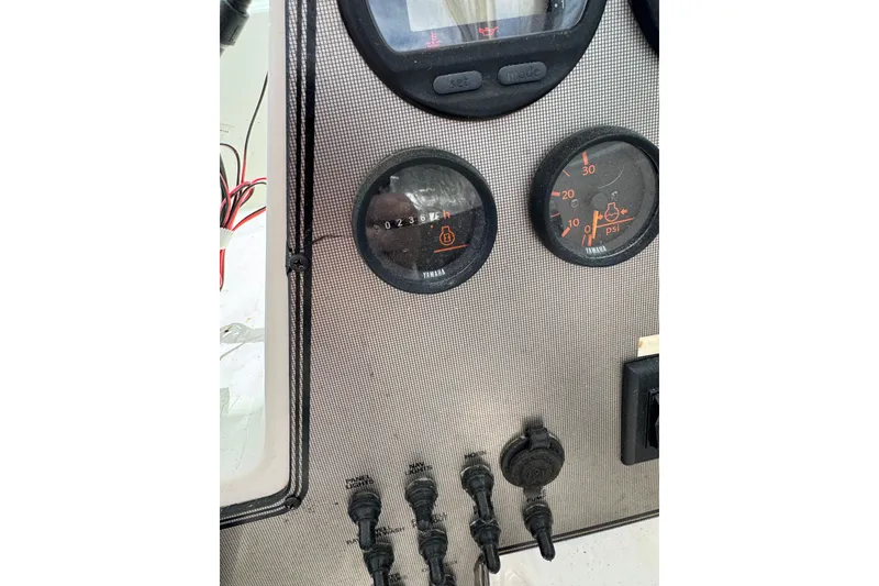 Slide: The Image of Dashboard of a 2000 Wellcraft 22 Coastal Walkaround O/B boat with gauges and switches. - 14