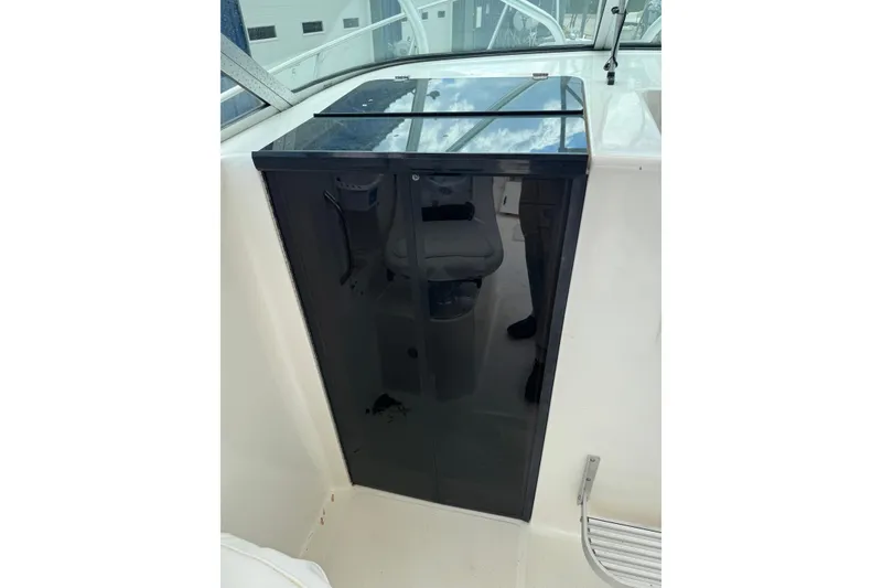 Slide: The Image of Wellcraft 22 Coastal Walkaround O/B 2000 cabin door with reflective surface and interior view. - 18