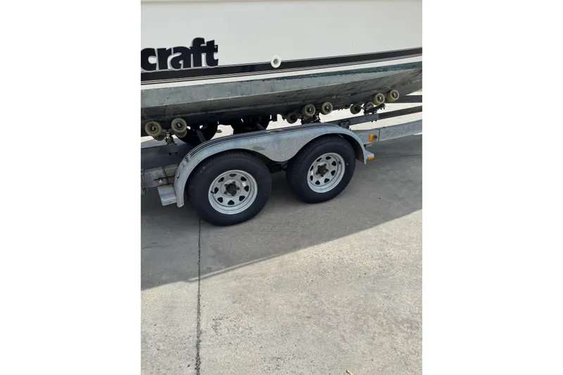 Slide: The Image of Trailer with Wellcraft 22 Coastal Walkaround O/B boat, 2000 model, on concrete surface. - 19