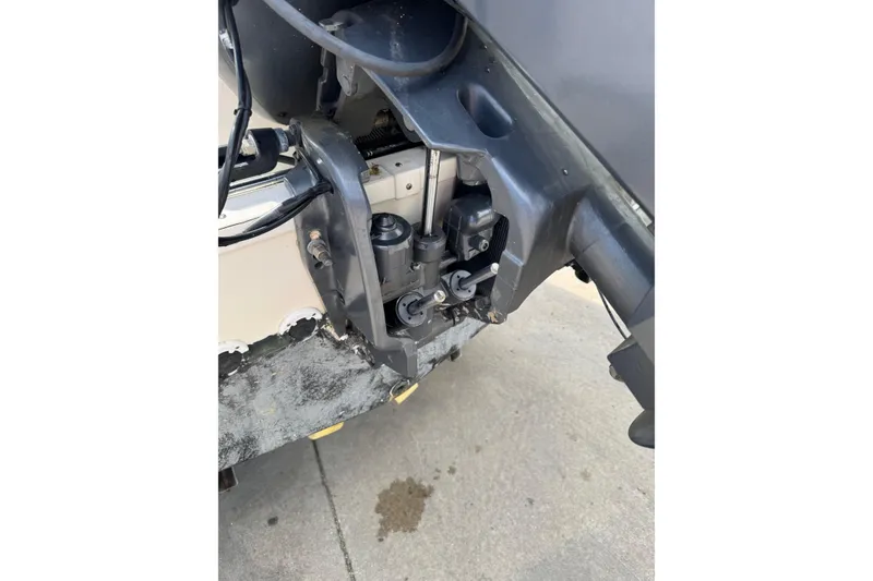 Slide: The Image of Outboard motor detail of 2000 Wellcraft 22 Coastal Walkaround boat on concrete surface. - 7