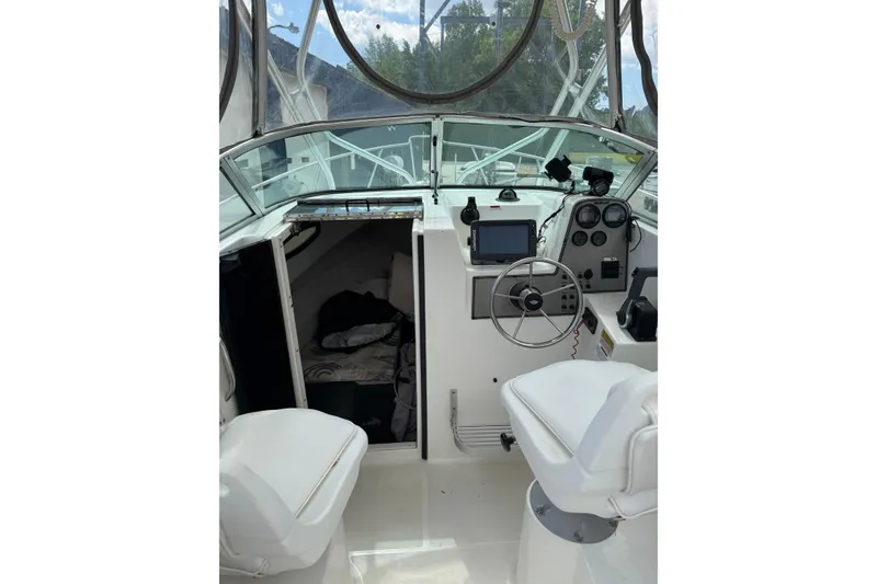 Slide: The Image of 2000 Wellcraft 22 Coastal Walkaround O/B boat interior with helm, seating, and cabin entrance. - 9